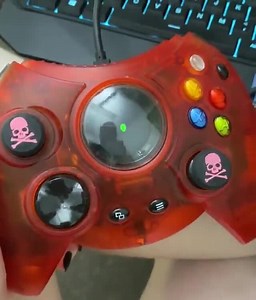 Saw another post sharing the unveiling of the original Xbox console and saw the OG duke controller. So I’m sharing my Xbox one Duke controller. It’s as cumbersome as you’d think, but I love to use it when playing original Xbox games that are playable on Xbox one :) And no, the original didn’t have the screen in the centre. Edit: this comes in black as the default, and it is also available in translucent red (like mine) and translucent green. The skull thumbsticks were also added by me, they’re n