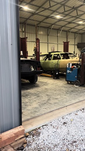 Car Restoration Process: Black Sedan in Workshop