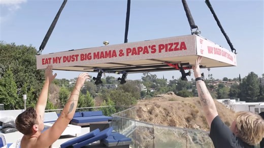 Delivering world’s largest pizza on the world’s smallest car - it required a crane