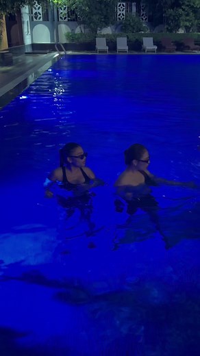 Nighttime Pool Fun with Friends in Serene Blue Lighting