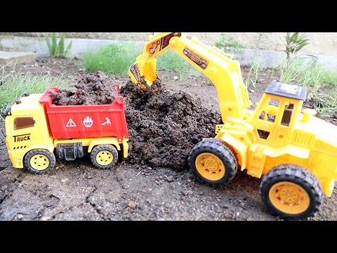 Bego excavator dan truk mainan mengangkut tanah