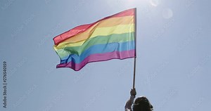 Pride LGBT rainbow flag waving in slow motion during a pride parade