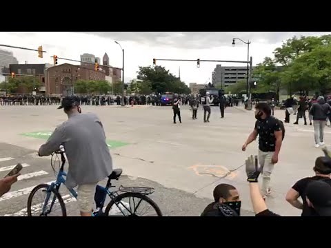 Protestors walking into Detroit riot police at end of “By All Means Necessary” march