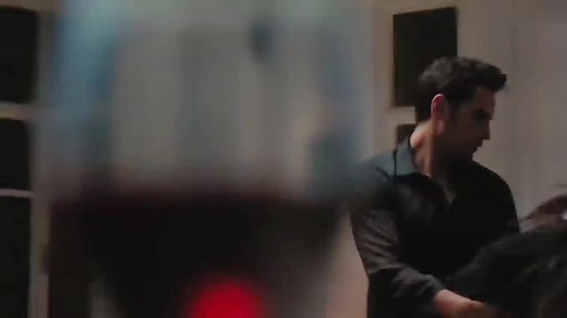 Emotional Embrace: Man Lifts Woman in Intimate Setting