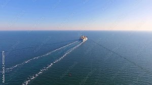 Aerial view of container ship floats in the open ocean after loading in the port of China at full speed. 4K.