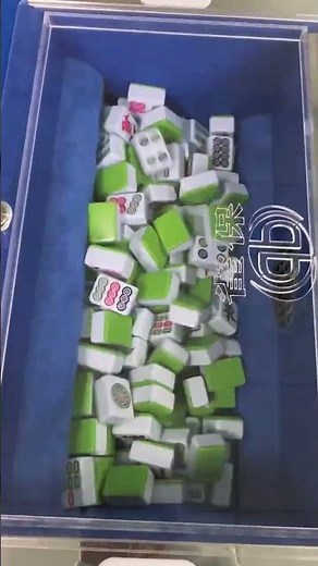 video shows an automatic Mahjong table that shuffles and stacks tiles for players.