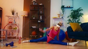 Humorous woman in retro sportswear doing splits at home, practicing acrobatics