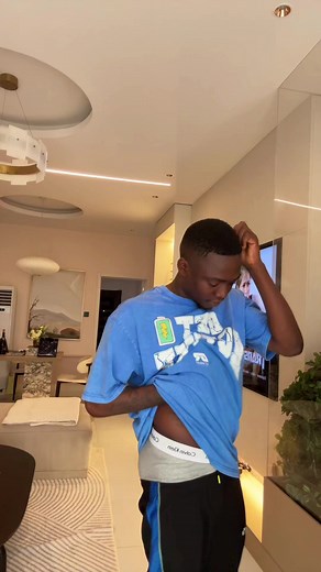 Stylish Living Room with Young Man and Tattoo