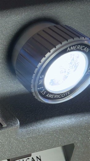 A vintage slide projector turned on and off