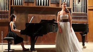 Woman pianist plays the piano and singer sing opera song Stock Video