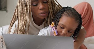 caring serious woman teaching her child to type, mom and her daughter using laptop, working on keyboard, sending message, e-mail, sms, surfing, browsing the net, internet