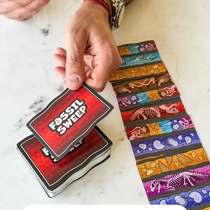 Uncover the fascinating world of fossils with SimplyFun's newest life & thinking card game, Fossil Sweep! Players take turns matching the fossil layers from the cards in their hands to the card layers on the dig site. The goal is to get rid of as many cards as possible before someone sweeps the dig away or runs out of cards, ending the round. Play with 2-5 players ages 8 and up in as little as 20 minutes. 🦖 Bonus! Includes a Fossil Fun Facts insert for more interactive learning! Trust us, this 