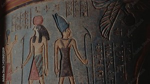 Ancient Egyptian hieroglyphs and figures carved on a clay pot. The artwork depicts pharaohs, deities, and symbols, showcasing the rich history and culture of Egypt. history, culture,