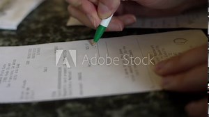 This close up video shows a hand signing a dinner check.