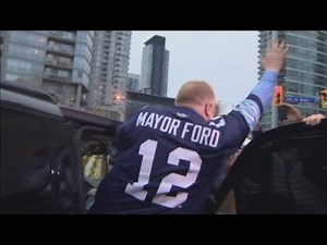 Toronto Mayor Rob Ford poses for photos whilst cheered at football match