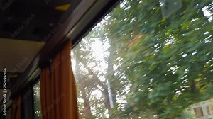 Glimpses of nature through a moving window's reflection in 4k slow motion 120fps