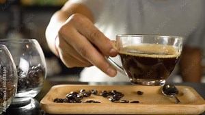 Barista making drip coffee by pouring spills hot water on coffee ground with prepare filter from copper teapot to glass transparent chrome drip maker. move black coffee to latte art in cafe shop.