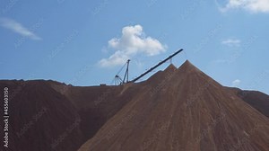 Mining industry close up. Telestacker handles the ore closeup for potash waste heaps, extraction of salt and potash fertilizers in a quarry and processing of ore