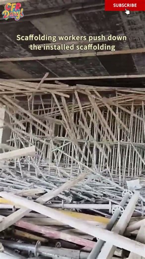 Scaffolding workers push down the installed scaffolding