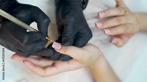 Nail care procedure in a beauty salon. Female hands and tools for manicure, process of performing manicure in beauty salon. Concept spa body care. The master applies varnish to the client's nails.