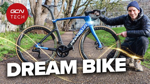 Si has finally taken delivery of his brand-new Pinarello Dogma F, finished in the stunning iridescent Luxter Blue Shiny paintwork. To take this superbike to the next level, Ollie Bridgewood has added six high-performance upgrades, including CeramicSpeed SLT bearings and a "controversial" gold derailleur hanger. Join Si as he breaks down the full tech specs, weighs the final build, and heads out for a rainy first ride. | GCN Tech