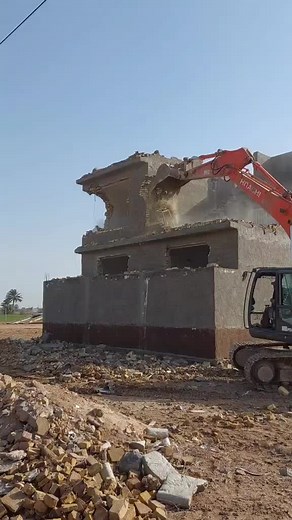 Demolition Process of a Concrete Building with Excavator