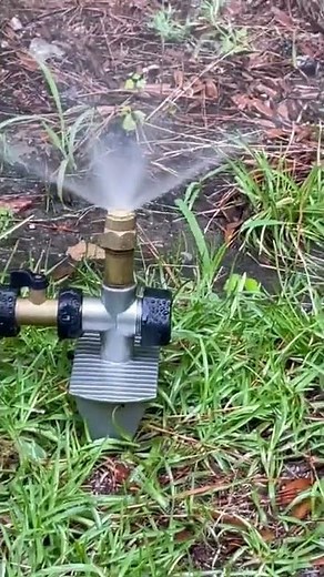 Orbit brass shrub nozzle with center strip spray pattern.
