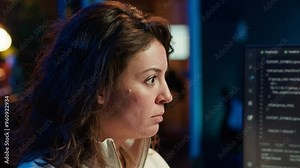 IT expert focused on looking for company security vulnerabilities and injected malware, close up. Programmer paying attention to PC screen, installing code to prevent cyber attacks, camera A