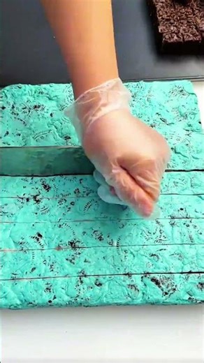 Knife slices turquoise sheet clean, crisp rhythm of morning cutting craft