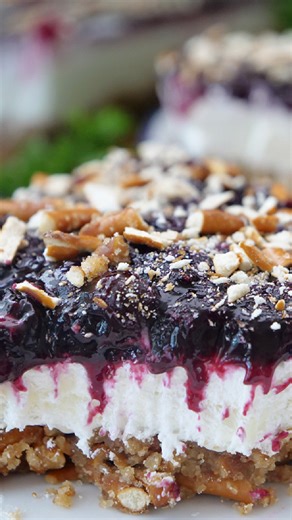 Blueberry pretzel salad is a sweet and salty dessert recipe made with a crunchy pretzel crust, a sweet cream cheese layer, and a blueberry topping. A winning combination of flavors that are simply irresistible. Ingredients: 2 ½ cups coarsely crushed pretzels ⅔ cup brown sugar 2 tablespoons all purpose flour 2 teaspoons vanilla extract ¾ cup butter, melted 1 ½ cups fresh blueberries ¼ cup sugar 1 tablespoon lemon juice 1 tablespoon cornstarch 8 ounces cream cheese 8 ounce cool whip 1 cup powdered