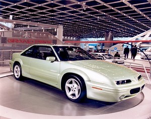 1993 Grand Prix Show Car – At the 1993 NAIAS, Pontiac presented this close-to-production (they said at the time) show car, highlighted by a new aero appearance package, a suede-finished, natural grain leather interior and a spoiler sunroof all in a two-door hardtop package. The show car’s exterior treatment – bathed in Mountain Mist Pearl paint – included clean and sleek fascias, aero-skirting, bodyside moldings and wheel flares filled with custom Goodyear 17” tires and five-spoke aluminum wheel