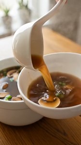 Japanese Clear Soup 🍲🌿 Ingredients: - 1 teaspoon sesame oil - 3 cups chicken broth - 2 cups beef broth - 2 cups water - 1 medium sweet onion, thinly sliced - 2 garlic cloves, lightly crushed - 1 medium carrot, thinly sliced - 1 inch fresh ginger, sliced - 4 ounces button mushrooms, thinly sliced - Salt to taste - 2 scallions, thinly sliced for garnish Directions: 1. Heat a soup pot over medium heat and add the sesame oil. 2. Add the sliced onion and sauté for 4–5 minutes until slightly softene