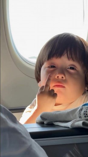 Kid Flips Off Camera on a Plane! 😂✈️(zhanabylov_e) #FunnyKids #PlanePrank #ViralMoments