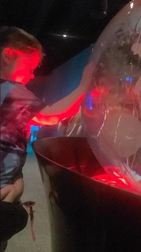 Toddler and water globe