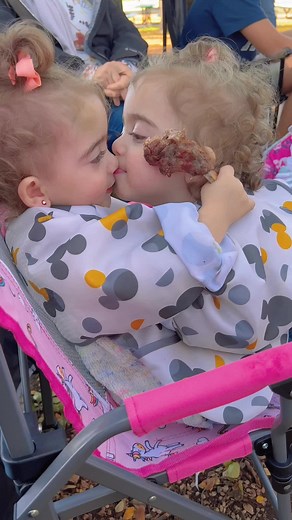 Twin Sisters Sharing Love Through Kisses and Hugs