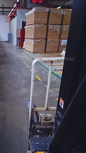 Production of wooden parquet. piles of parquet boards inside the factory of furniture industry. view from forklift cart. vertical video | Vídeo de estoque Premium