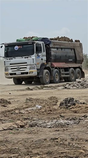 A 12-wheel Korean truck is transporting earth in Cambodia.