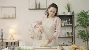 Happy young female cooking in kitchen, enjoying hobby, preparing meal for family