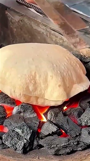 the process of baking a wide, unique dough over charcoal #shorts
