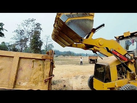 Caterpillar Loader Digging Soil And Loading Into Tractor Trailer