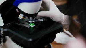 Scientists to rotate the lens of a microscope with slide and green light