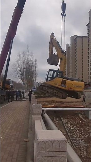Process of Hoisting Excavator at Construction Site