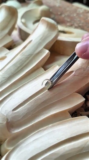 carving intricate patterns on wood using various chisels to create smooth and detailed ornaments