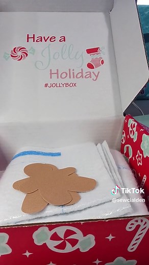 2023 Jolly Box reveal part 3. Included in the box is a June Tailor Quilt As You Go appluque potholder kit. Includes gingerbread cut outs made with AccuQuilt die cutter system. Thermal printed batting. You will have to add 4-5 fat quarters. I have this system, have the gingerbread cookie die, and offers a free embroidery file to use with your embroidery machine. #fatquartershop #sewing #quilting #machineembroidery #applique