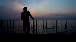 Download Thoughtful alone man silhouette with seaview for free