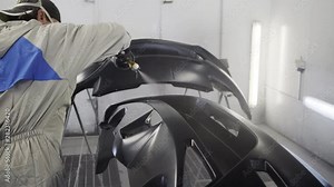 Master is processing details of automobile by anti-corrosion liquid, spraying