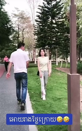 Humorous Park Walk: Woman Trips While Strolling