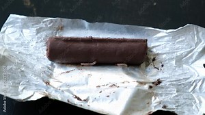 Worms crawls on chocolate candy. Crawling larvae and eggs laid on food. Not fresh spoiled product. A disgusting sight. Sickening and disgusting. Violation of storage conditions in a grocery store. 4K Stock Video