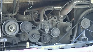 Working bus, truck diesel engine with motor belt, pulley, gear, engine equipment details.