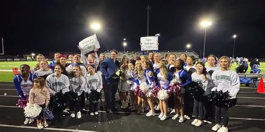 High school cheerleaders help surprise coach with sideline proposal